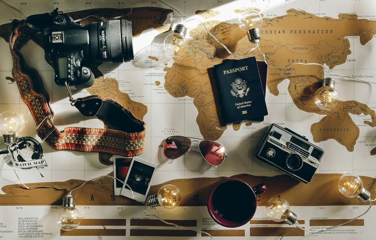 Travel planning flat lay with a map and luggage essentials